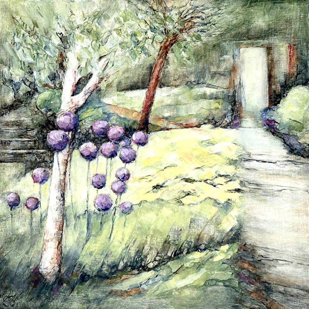 Purple Alliums and yellow daylilies beside the garden path